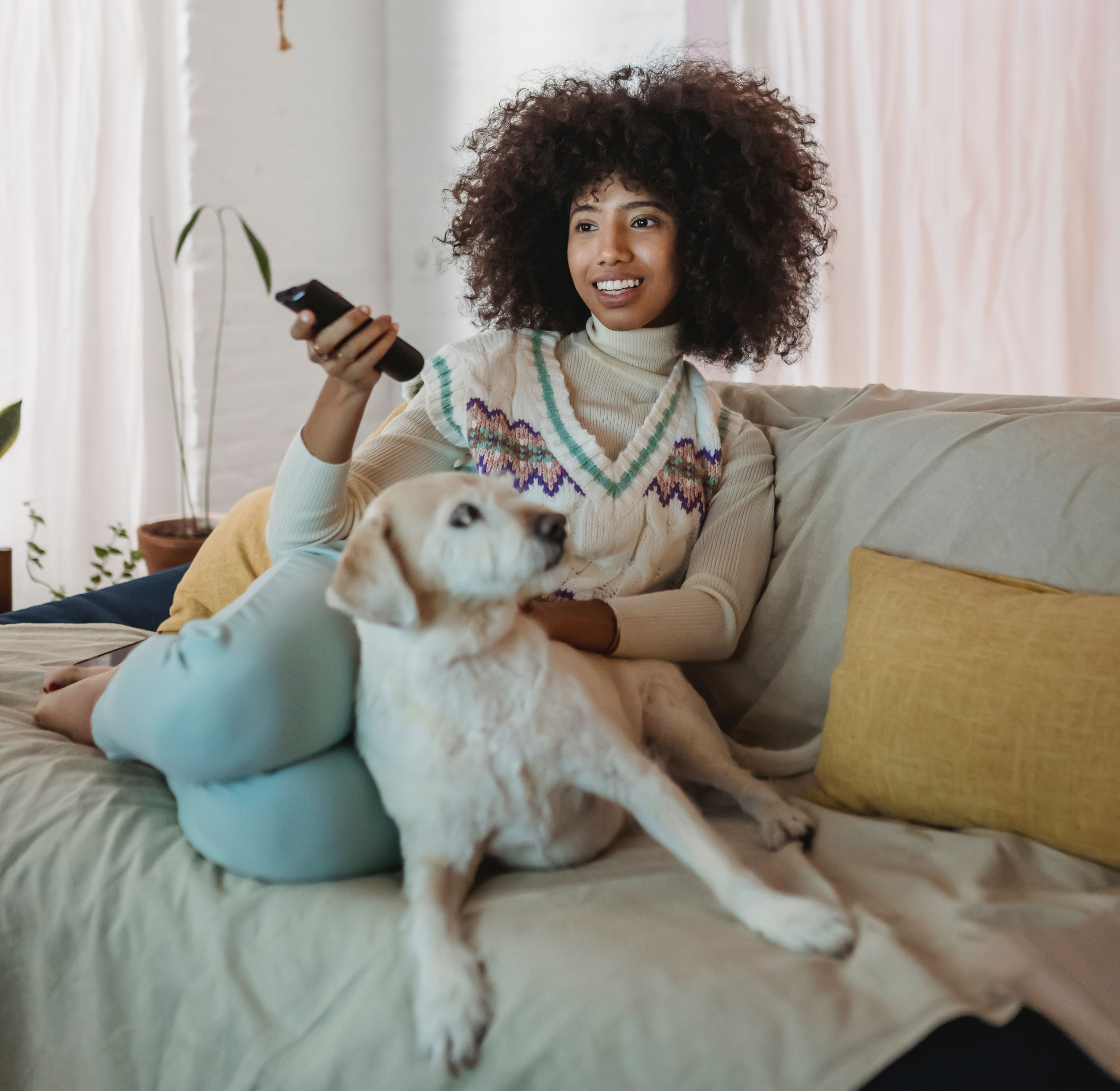 Woman with dog, watching TV